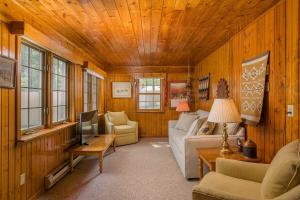 a living room with a couch and a tv at Lake House Vacation Sleeps 12 Private Dock in Waupaca