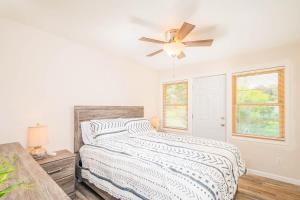 a bedroom with a bed and a ceiling fan at Luxury at Liberty Street in Green Bay