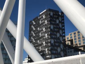 a tall building in the middle of some buildings at Barcode Oslo - Two-bedroom Apartment in Central Oslo in Oslo