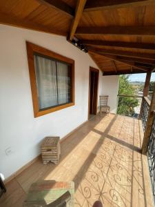 an empty patio with a wooden ceiling and a window at Suítes Encanto de Minas in Tiradentes