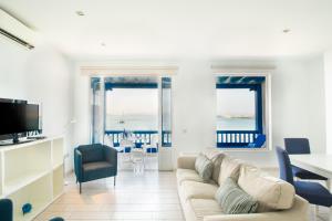 a living room with a couch and a table and chairs at Blancazul Alto Brisa in Playa Blanca