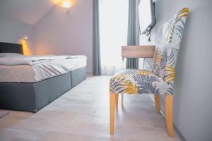 a bedroom with a chair next to a bed at House Evermore 2 in Lovinac +30 photos