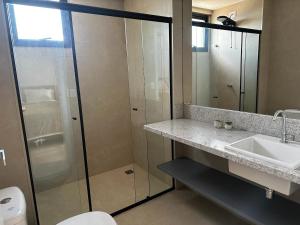 a bathroom with a shower and a sink and a toilet at PARK SUL - Edifício Essence - 4 in Brasilia