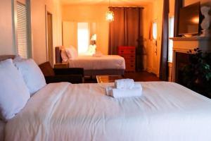 a hotel room with a bed with two towels on it at Work Crew Haven: Spacious Corporate Lodging in Lafayette