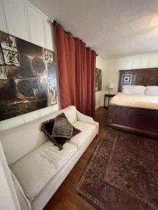 a living room with a couch and a bed at Work Crew Haven: Spacious Corporate Lodging in Lafayette