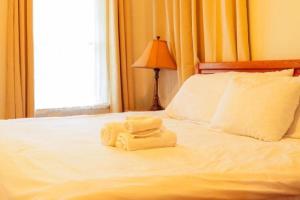 two towels sitting on top of a bed at Work Crew Haven: Spacious Corporate Lodging in Lafayette