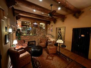 a living room with couches and a stone fireplace at Casa Sedona Inn in Sedona