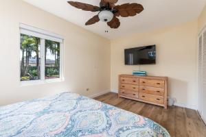 a bedroom with a bed and a flat screen tv at Charming Multi Family 3 Bedroom with a Pool - Great Location in Dania Beach