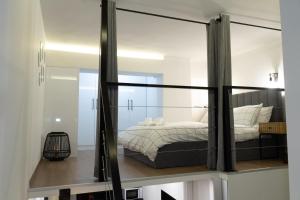 a bedroom with a bed in a room with a mirror at CozyLoft 2 in Patra