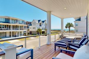 a balcony with chairs and a view of the ocean at Oceans 12 in Wrightsville Beach