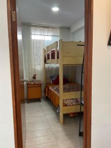 a bedroom with a bunk bed in a room at Disfruta de Mollendo in Mollendo