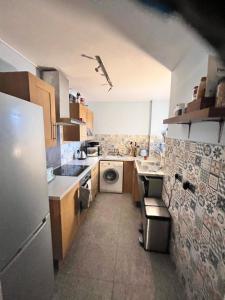 a kitchen with a refrigerator and a washing machine at Cozymodernroom in Brighton & Hove +14 photos