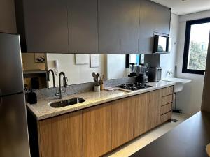 a kitchen with a sink and a counter top at PARK SUL - Edifício Essence - 7 in Brasília