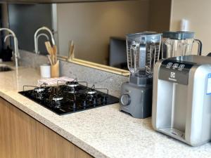 a blender sitting on a counter next to a stove at PARK SUL - Edifício Essence - 7 in Brasília