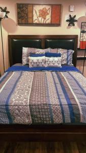 a bed with a blue and white quilt on it at PRIVATE ENTRANCE APT RooM #4 in Dallas