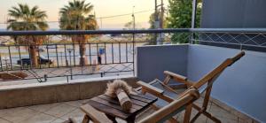a wooden chair sitting on a balcony with ainylinylinylinylinylinylinyl at Slanchev Apartment in Ofrínion