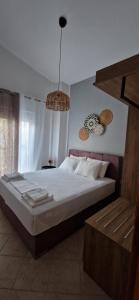 a bedroom with a large bed in a room at Slanchev Apartment in Ofrínion