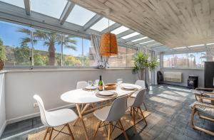 a dining room with a white table and chairs at La Cala golf and Sun apartment in Mijas
