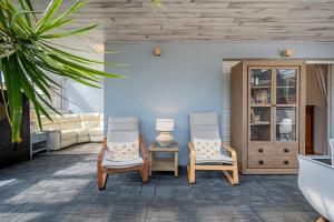 a living room with two chairs and a couch at La Cala golf and Sun apartment in Mijas