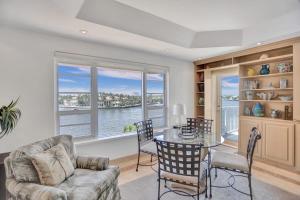 a living room with a table and a view of the water at Fort Lauderdale Yacht & Beach Club 411 in Fort Lauderdale
