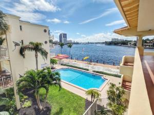an apartment balcony with a swimming pool and a view of the water at Fort Lauderdale Yacht & Beach Club 411 in Fort Lauderdale
