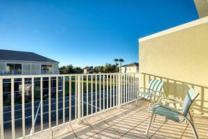 a patio with two chairs on a balcony at Super cozy home with private pool in Orlando