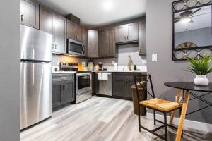 a kitchen with stainless steel appliances and a table at Restaurants-Pets-Professionals-FastWiFi-A C-Patios in San Diego