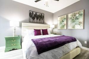 a bedroom with a purple bed and a green night stand at Restaurants-Pets-Professionals-FastWiFi-A C-Patios in San Diego