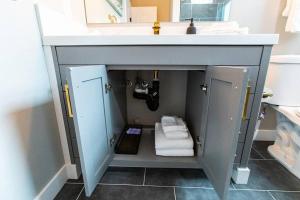 a bathroom with a sink with towels under it at Restaurants-Pets-Professionals-FastWiFi-A C-Patios in San Diego