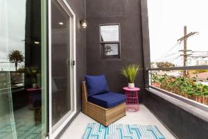 a balcony with a blue chair and a window at Studio - Balcony - A C - Dogs Parks Restaurants in San Diego