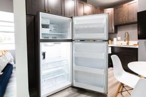 a refrigerator with its doors open in a kitchen at Studio - Balcony - A C - Dogs Parks Restaurants in San Diego