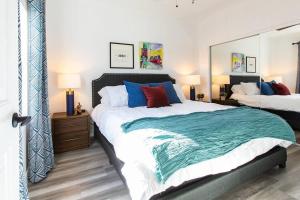 a bedroom with a large bed and a large mirror at Walk 2 Restaurants & Bars-Relax on Private Patio in San Diego