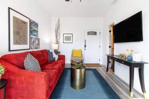 a living room with a red couch and a table at Walk 2 Restaurants & Bars-Relax on Private Patio in San Diego