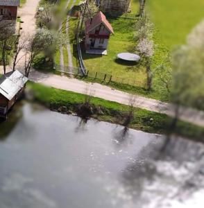 an aerial view of a pond with a house at River View Tiny House with Garden in Šipovo