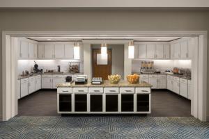 a large kitchen with white cabinets and a large island at Homewood Suites Hillsboro Beaverton in Beaverton