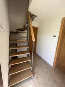 a metal staircase in a room with a wall at River View Tiny House with Garden in Šipovo