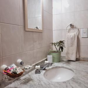a bathroom with a sink and a mirror at Posada El Prado in Salta