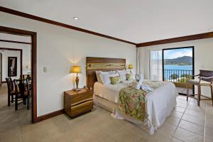 a bedroom with a bed with a view of the ocean at Remodeled Top-Floor Flamingo Condo with Outstanding Ocean Views in Playa Flamingo