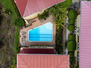 an overhead view of a swimming pool in a house at Remodeled Top-Floor Flamingo Condo with Outstanding Ocean Views in Playa Flamingo