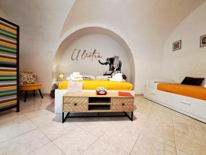 a bedroom with two beds and a sign that reads welcome at U Liotru home in Catania