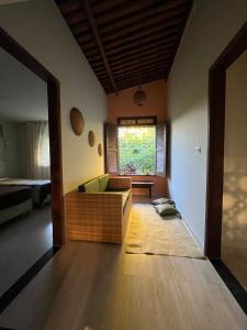a living room with a couch and a window at Granja Raio de Luz in Igarassu
