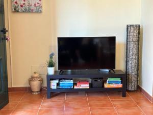 a flat screen tv on a black entertainment center at Desconectaengalicia La Lanzada, 200m playa in A Lanzada