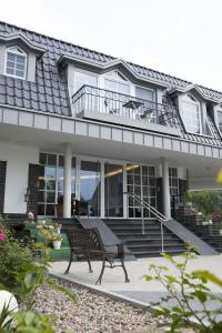 a bench sitting in front of a house at Hotel Lange in Leer