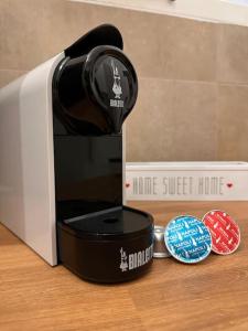 a coffee maker sitting on a table next to a box at Casa Manú centro Bologna in Bologna