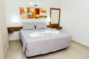 Postel nebo postele na pokoji v ubytování Hotel Fernandão