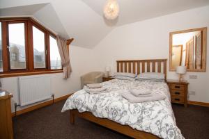 a bedroom with a bed with towels on it at Alder Lodge Guest House in Lerwick