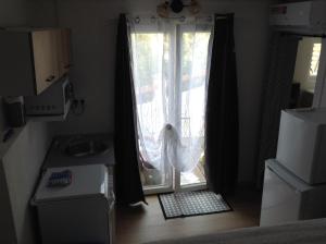 a room with a sliding glass door with a window at la loggia in Porto-Vecchio +4 photos