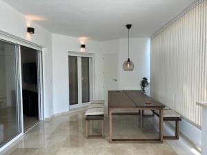 a dining room with a wooden table and chairs at Stunning groundfloor apartment - MO2802LT in Los Tomases