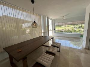 a large wooden bench in a room with a large window at Stunning groundfloor apartment - MO2802LT in Los Tomases