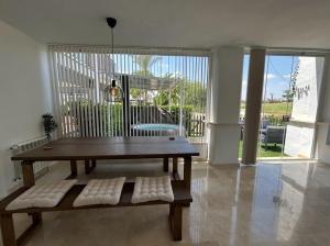 a living room with a wooden table and a bench at Stunning groundfloor apartment - MO2802LT in Los Tomases